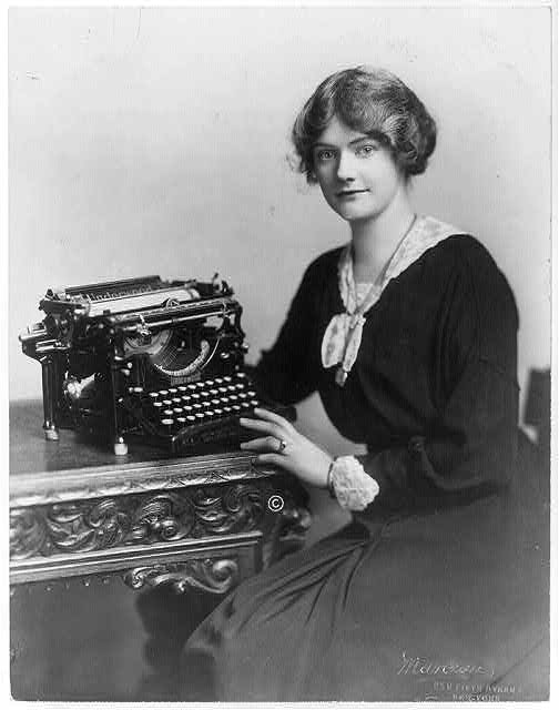 Black and white photo of young woman with Underwood typewriter