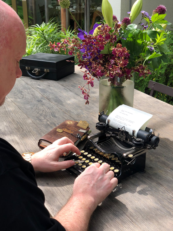 Man types on a Corona 3 typewriter