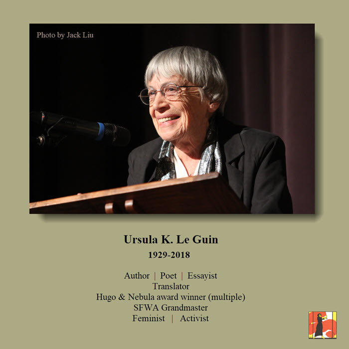 Ursula K Le Guin stands at a lectern. Shows an older white woman with short, bowl-cut white hair & glasses. She is smiling. Text below image lists some of her key credentials: Author, Poet, Essayist, Translator, Hugo & Nebula award winner (multiple), SFWA Grandmaster, Feminist, Activist