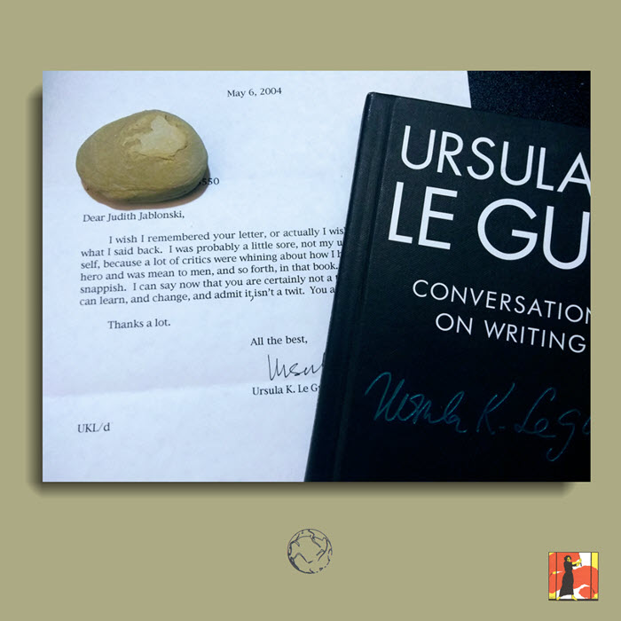 College image shows portion of a letter I received from Ms. Le Guin. A stone covers the return address. To the right is a partial view of the cover of the book Ursula K. Le Guin: Conversations on Writing.